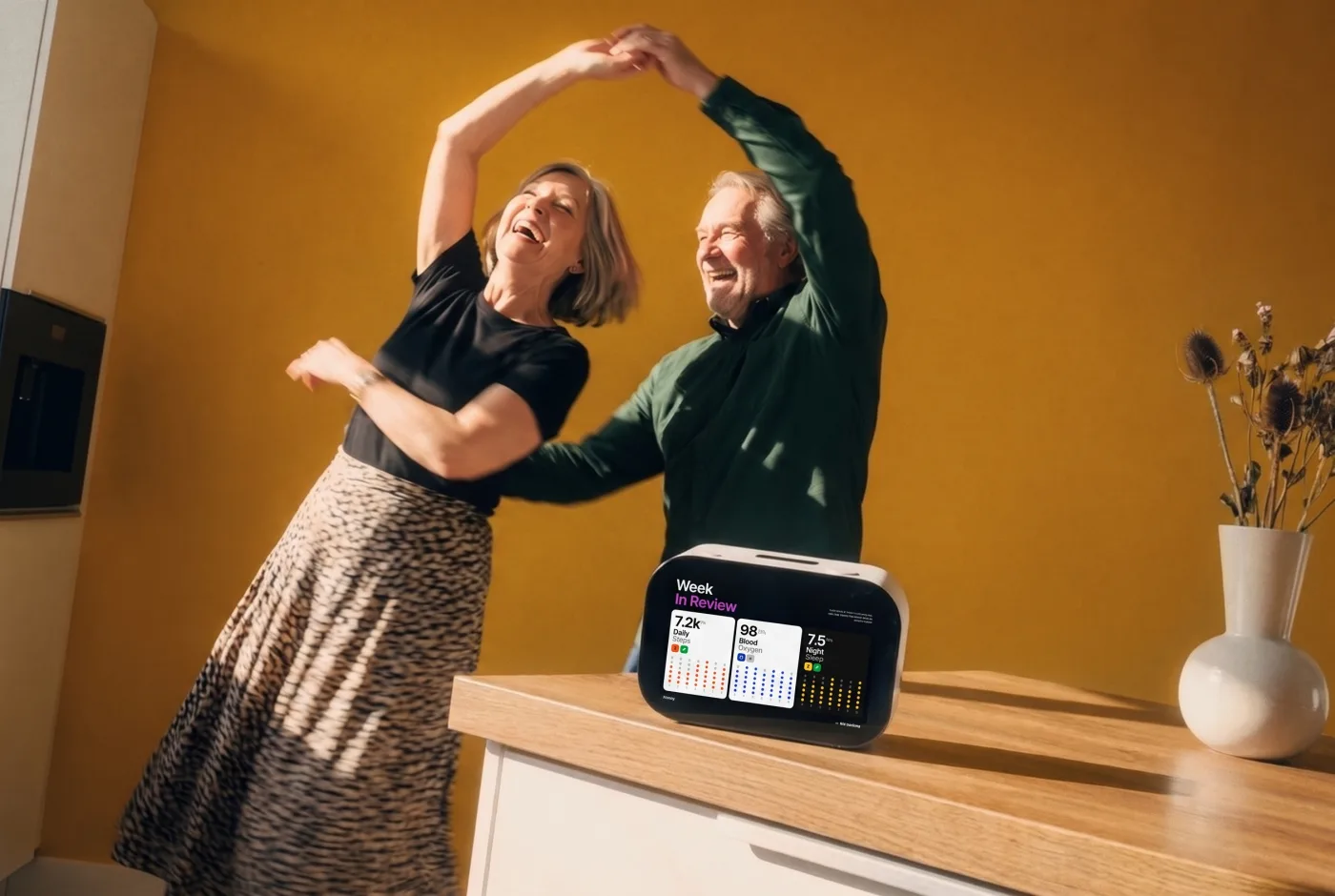 Older couple dancing at home while Rhem shows their weekly health summary